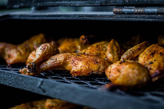 delicious looking roasted chicken with spices on a grill